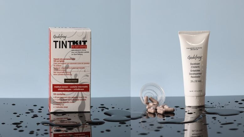 Godefroy Tint Kit box and developer on wet surface