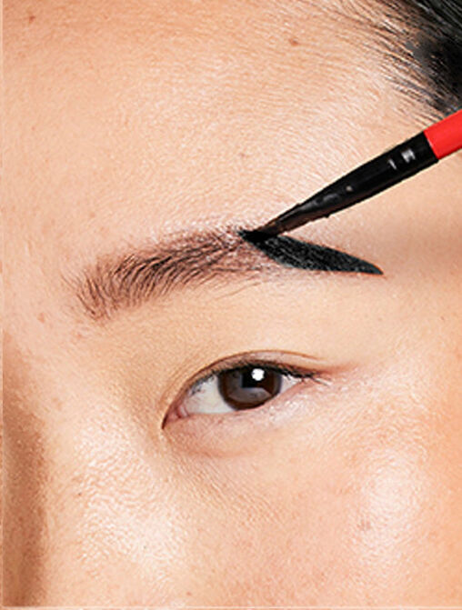 woman applying natural black eyebrow tint on eyebrows