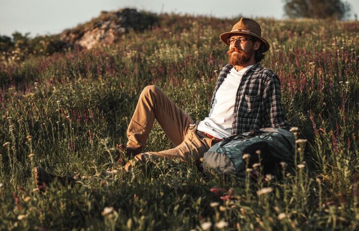 man laying in field with beard