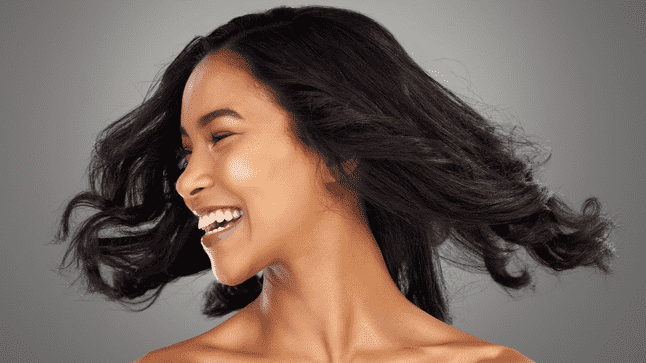 Woman with dark hair shaking her head