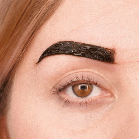 woman tinting eyebrows