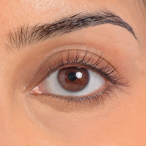 women using eyelash curler