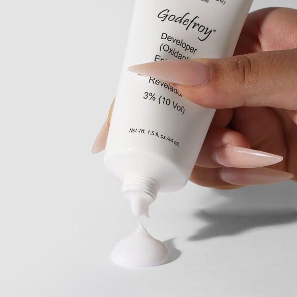 Womens hand holding Godefroy developer