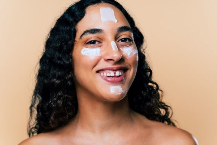 woman with moisturizer on her face