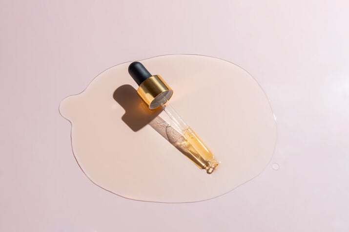 skincare dropper in pool of serum