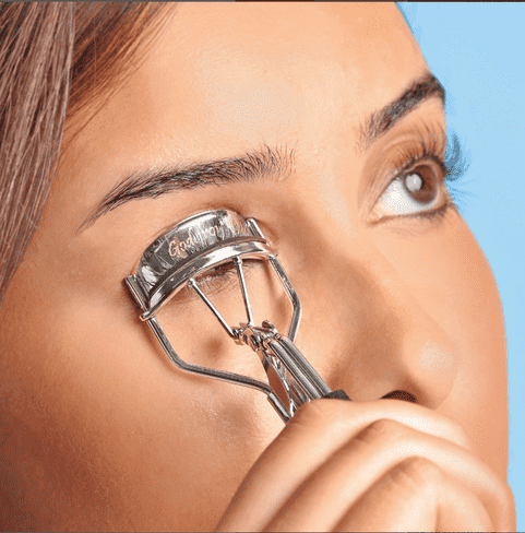 women using an eyelash curler