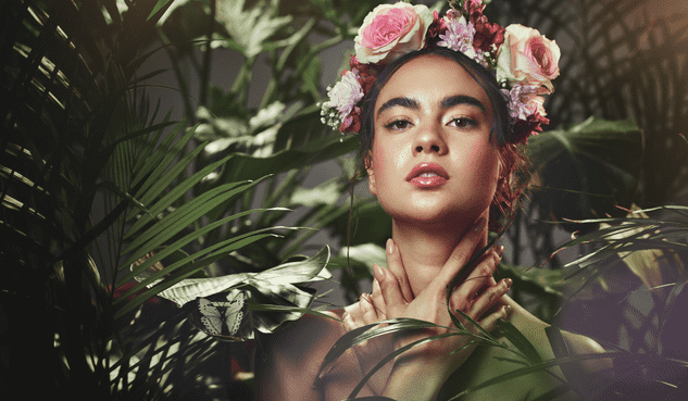Woman with a flower crown posing with leaves