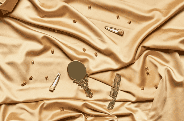 gold hair care on a gold sheet