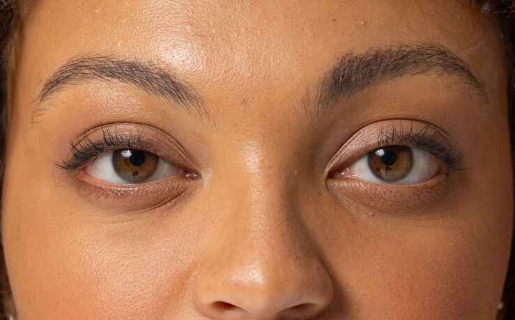 Close-up of woman's brown eyes and eyebrows