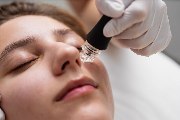 microdermabrasion tool on women's face