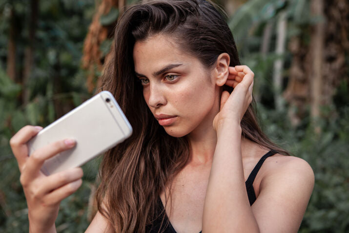 women with green eyes taking selfie