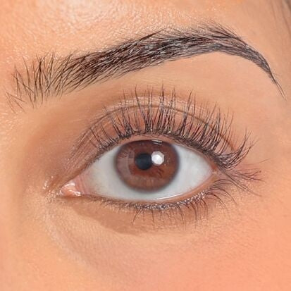 women using eyelash curler