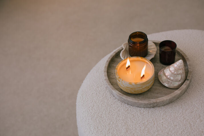 a lit candle and seashells