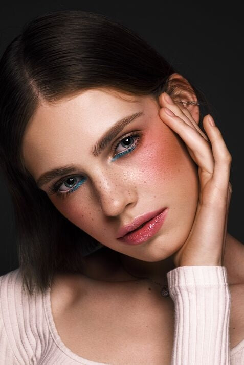 Beautiful woman with blue and pink makeup