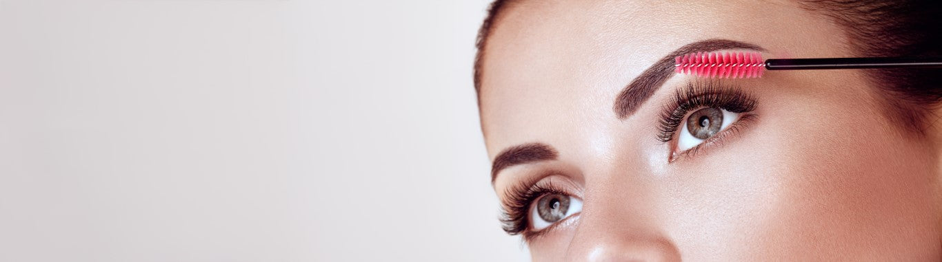Close up of woman brushing her false lashes