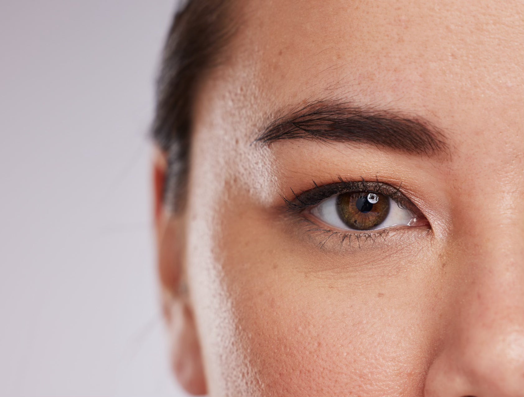 Half portrait of a woman with dark brown brows