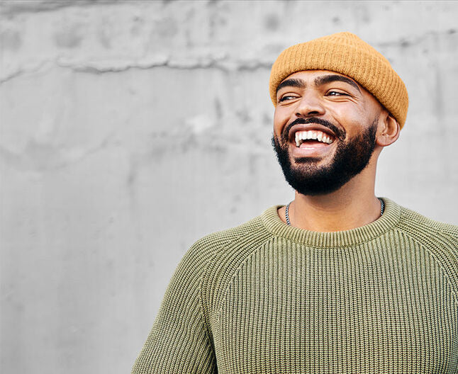Excited young man with a beard and thick eyebrows