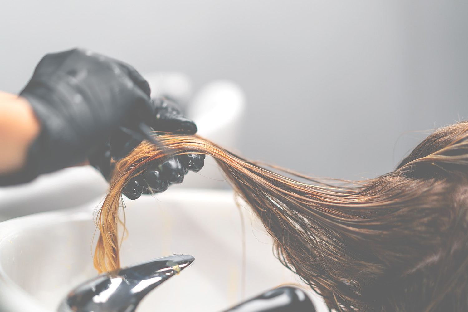 applying hair color to strands of hair
