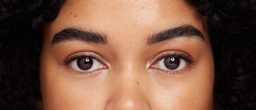woman with dark lashes and dark brows