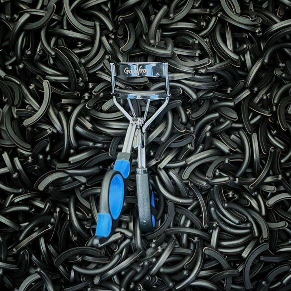 Eyelash curler on top of black rubber pads