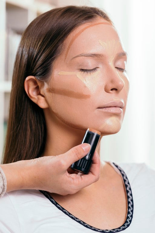 woman getting makeup done with contour