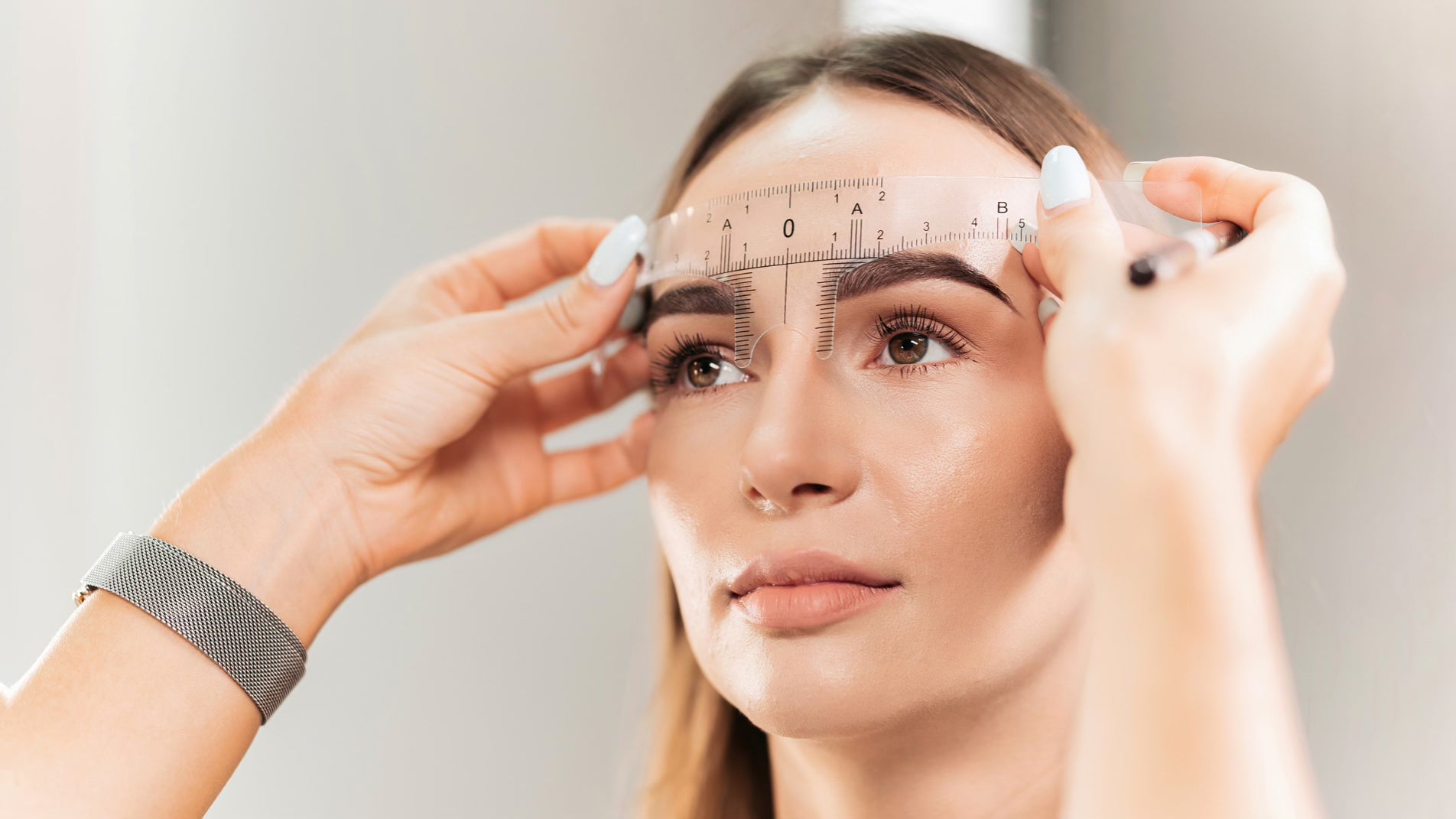 Woman getting her eyebrows measured