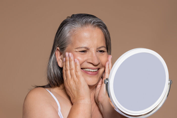 Older woman smiling in mirror