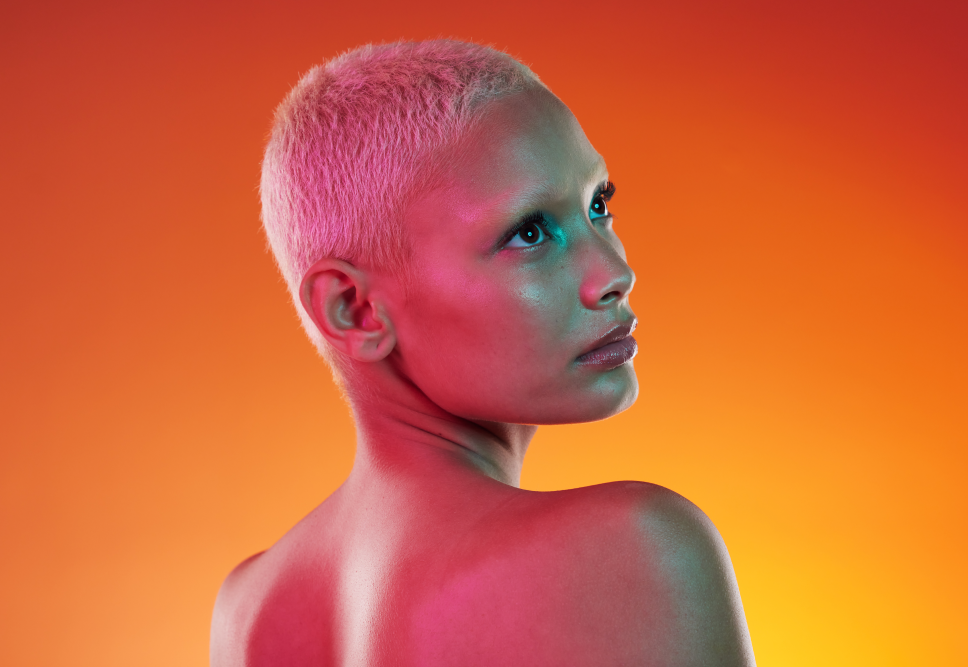 woman with short hair and orange background
