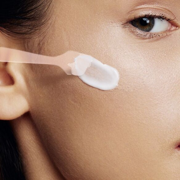 woman skin care product with application spatula
