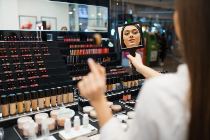 woman at makeup store testing products