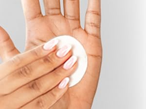 closeup of using cotton round on hand