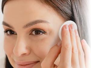 Smiling women using cotton round