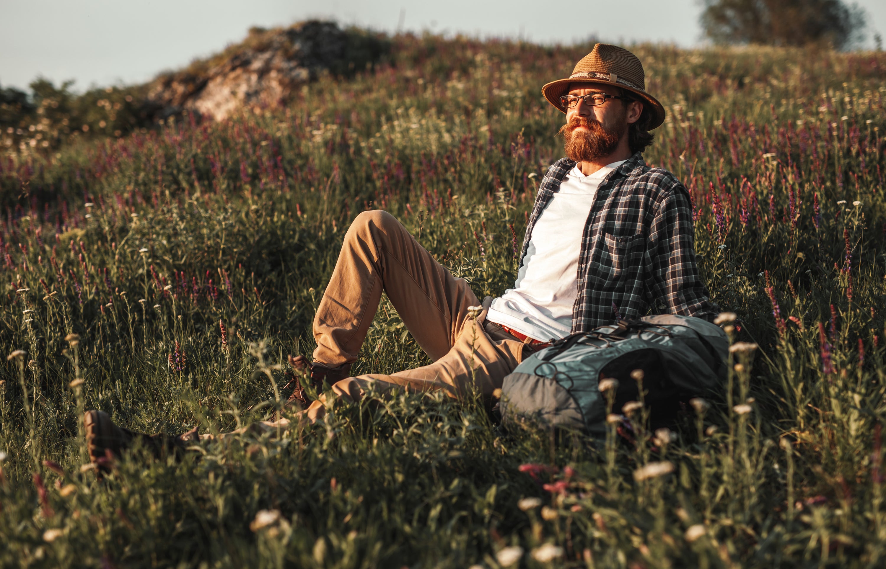 man laying in field with beard 