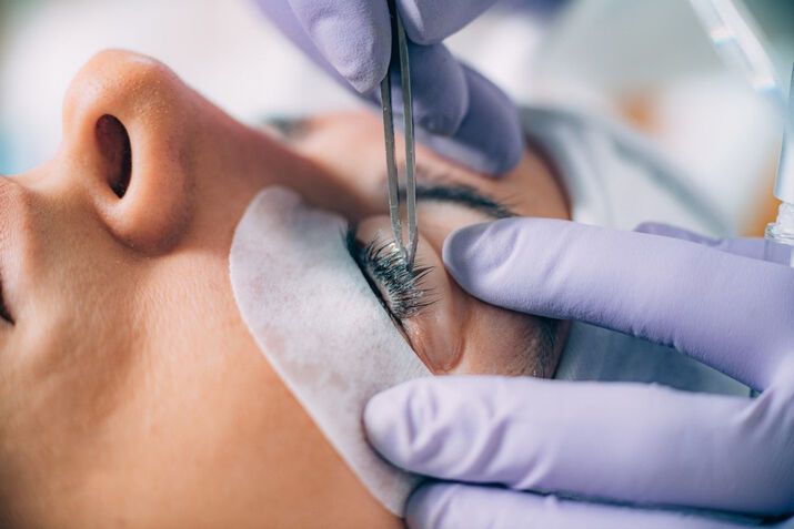 woman getting professional eyelash extensions