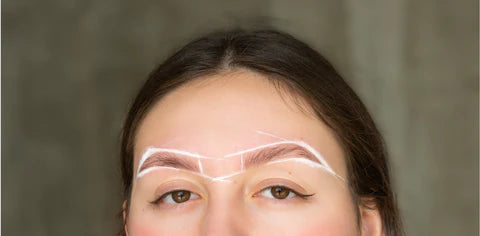 woman mapping out her eyebrows 