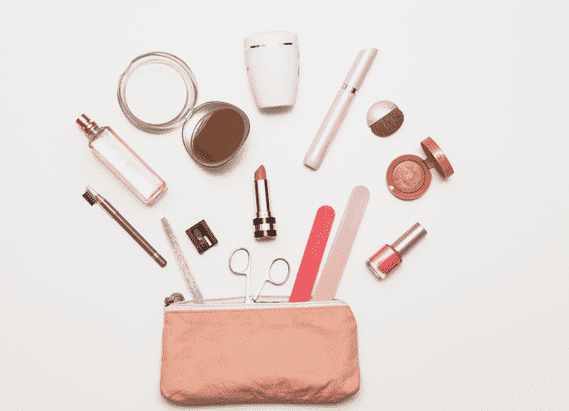 Pink makeup bag with makeup products and tools