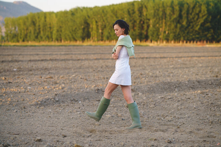 Woman with white dress and boots walking