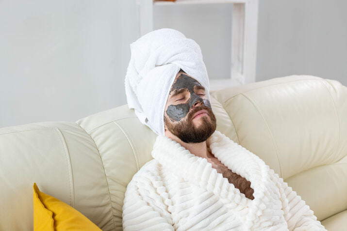 man relaxing with face mask