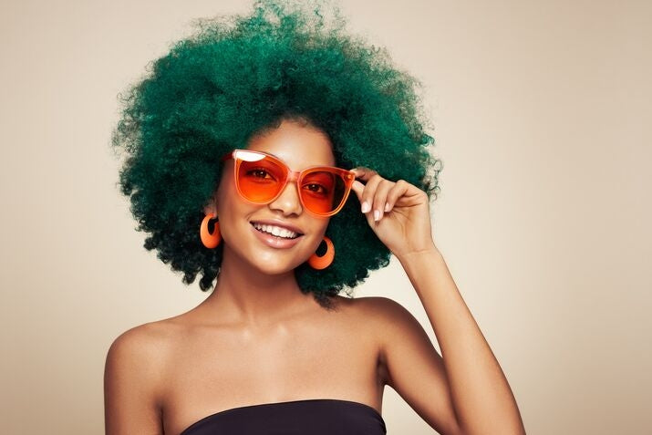 woman with colorful green afro