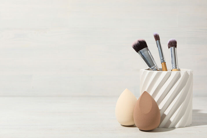 Makeup brushes and sponges with a white background