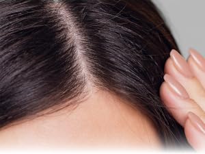 close up of woman's dark hairline