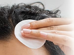 Close up of women using cotton round on forehead
