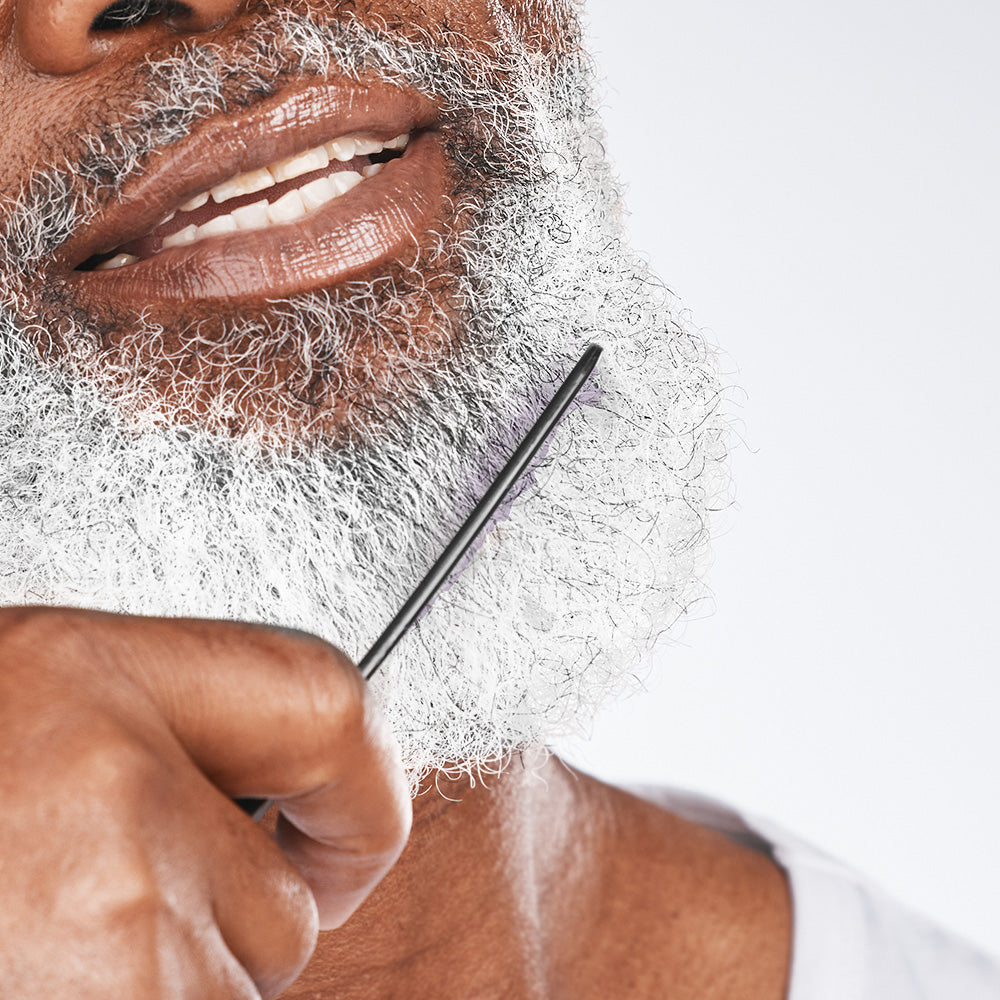 senior black man combing grey beard