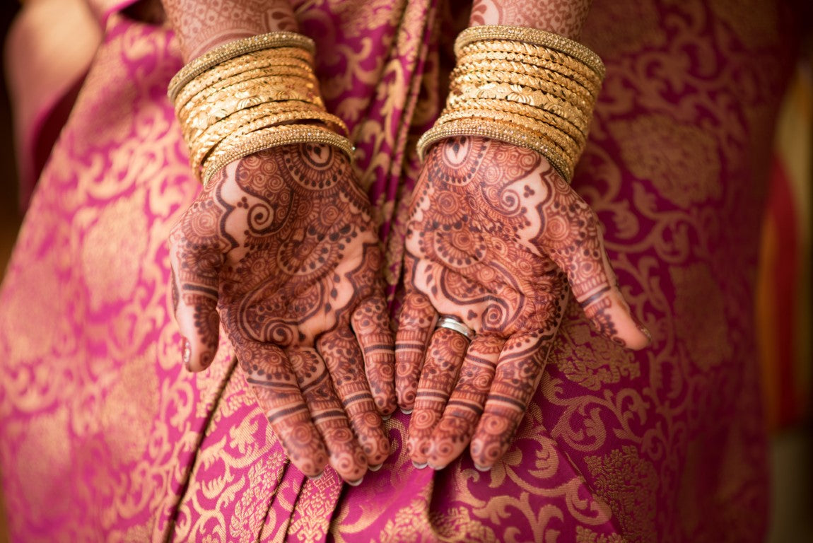 woman hands with henna tattoos