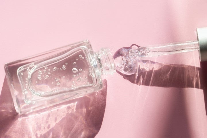 Clear cosmetic bottle spilling out