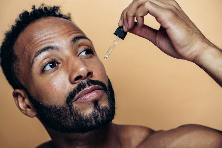 man with beard applying beard oil