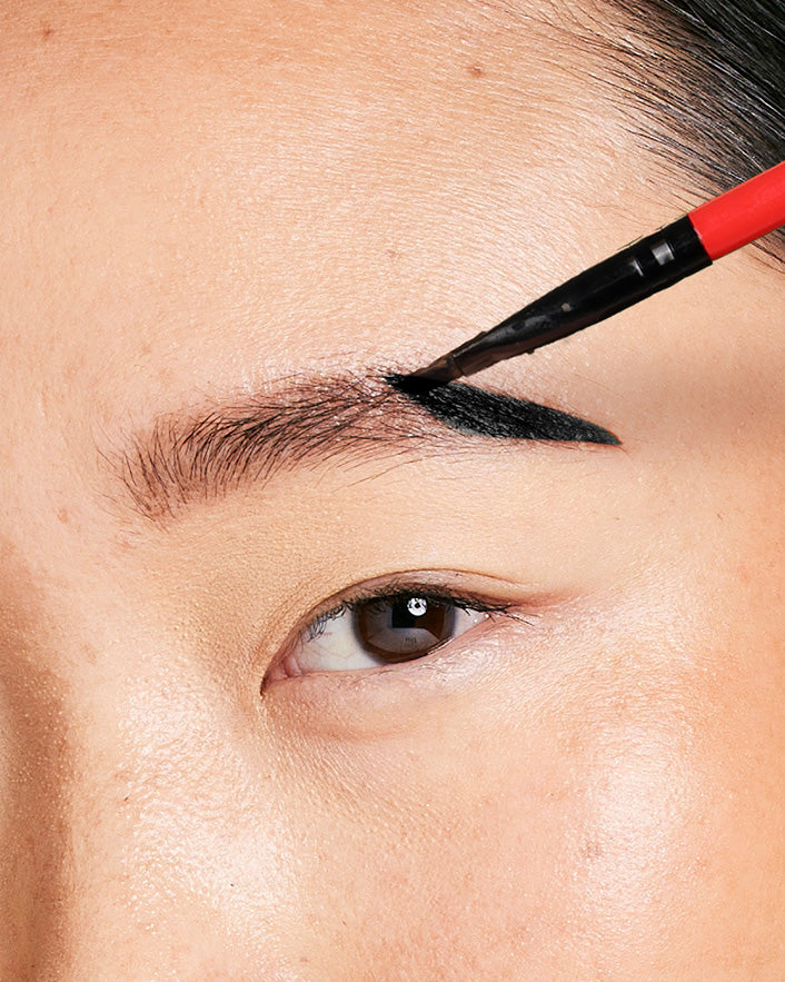 woman applying eyebrow tint