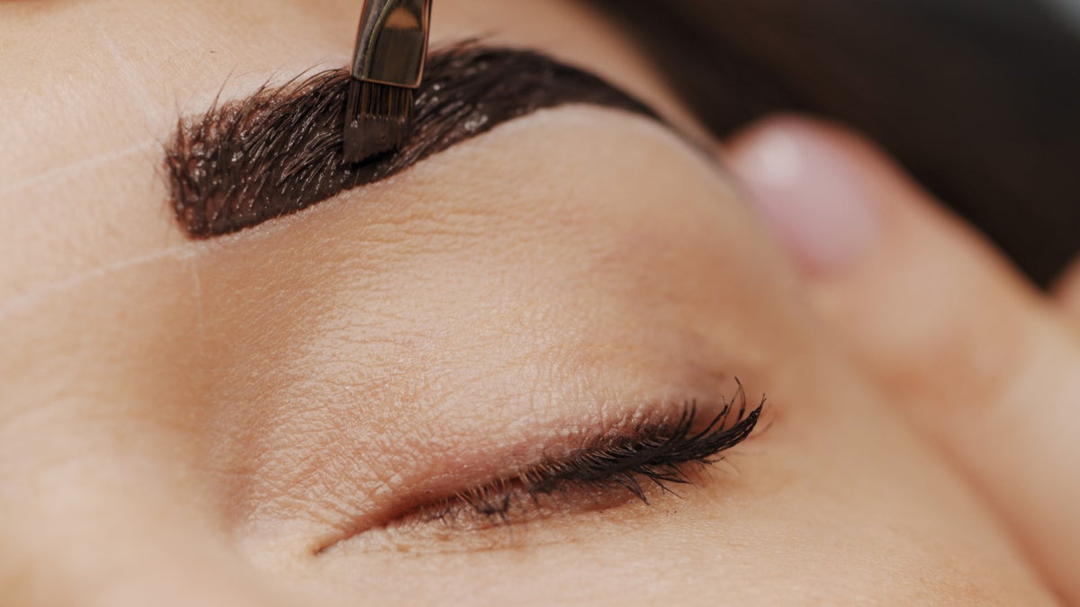 woman getting microblade brows at salon